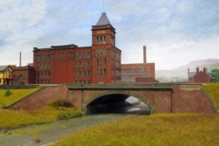 The railway crosses the disused Rochdale Canal with Alpha Mill behind